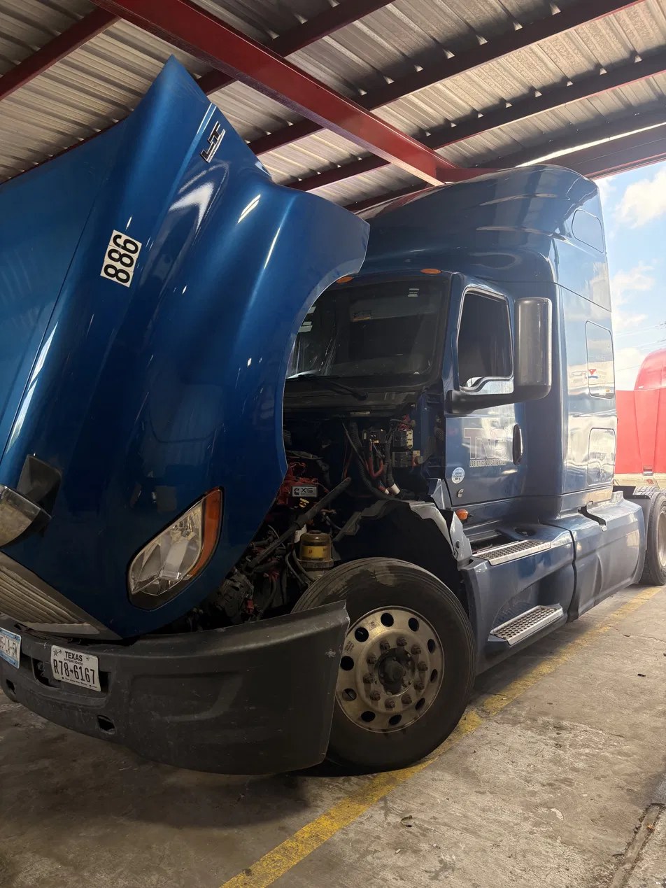 Blue Freightliner in the shop at Techni Solutions